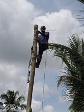 Man up pole installing wiring for light