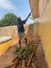 painting the exterior of a classroom at Dekpor Basic School
