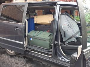 Carol's van is loaded with shipping bags and suitcases
