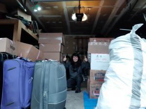 A view of Carol's garage and the 44 suitcases, shipping bags, and boxes