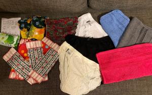 the contents of a kit spread out to see the underwear, facecloths, soap, pads, etc.
