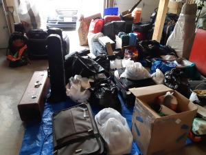 countless suitcases, bags, boxes, and piles of goods for donation