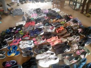 Shoes sorted in pairs cover the floor